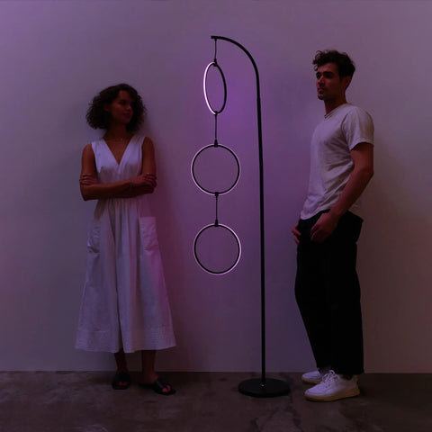 Dope RGB Color Changing Floor Lamp With Arching Three-Ring Pendant, Modern Corner Or Over-The-Couch Standing Light, Dimmable LED, Black Sleek Finish, Elevate Living Rooms With Ultra-Contemporary Vibe with two people for scale