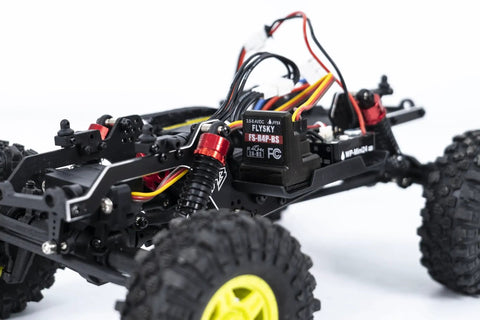 Close-up of 1/18 RC Crawler Pro Juice Up Edition RTR with HBW Electronics showing brushless power setup and rugged tires.