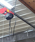 Four Wheel Unistrut Trolley Rollers Heavy Duty 650 Pound Capacity installed on ceiling track with lifting eye nut and M12 bolt