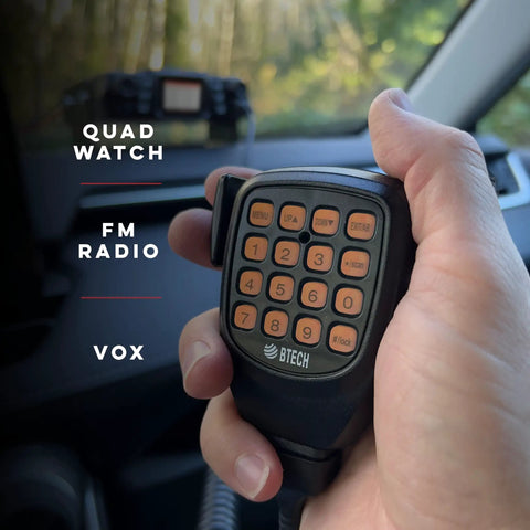 Hand holding microphone of UV50X2 Second Gen Beefy 50 Watt Dual Band Base Mobile Radio for VHF UHF Amateur Ham in car setting