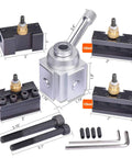 Front view of mini lathe quick-change tool post with AXA-style tool holders, silver post, mounting bolts, and hex keys.