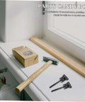 Window ledge with hammer, wood plank, cardboard box, two black T-shaped tools