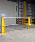 Heavy Duty Cantilever Dock Gate 12 Foot Wide Double Action Slick Pneumatic Struts in yellow, installed in a warehouse loading bay.
