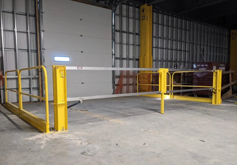 Heavy Duty Cantilever Dock Gate 12 Foot Wide Double Action Slick Pneumatic Struts in yellow, installed in a warehouse loading bay.