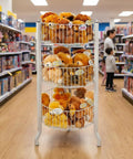 Three Tier Round Wire Dump Bins Display Stand For Retail Floors, white finish, filled with plush toys in a store aisle