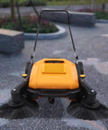 Workhorse Walk Behind Outdoor Sweeper, No Fuss Hand Push Pavement Cleaner features dual side brushes for efficient cleaning.