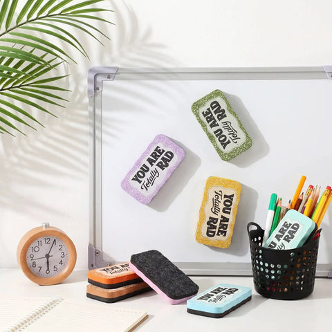 8 Pcs Magnetic Dry Erase Erasers Set In Macaron Colors for Whiteboards with notebooks and clock on a desk