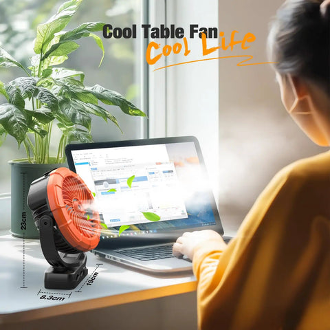 Portable Misting Clip On Fan With 100ml Water Tank cooling workspace, LED light and mist next to laptop in sunlight.