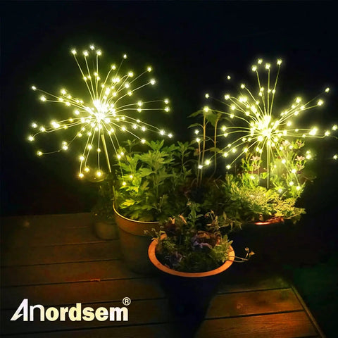 Solar Garden Lights Outdoor With Bendable Copper Wire And 120 LED Firework Beads illuminating potted plants at night