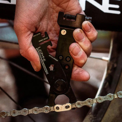Hand holding All In One Bike Chain Tool With Quick Link Pliers, Chain Breaker, Magnetic Link Storage for trail repairs
