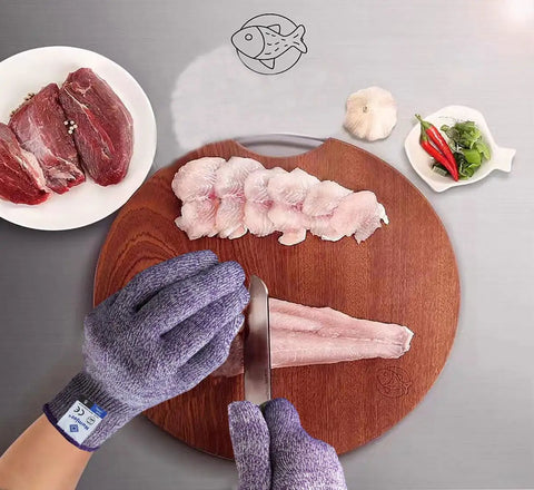Person using Pro Chef Cut Resistant Kitchen Gloves EN388 Level 5, Food Grade Safety Gloves, Violet Medium while filleting fish