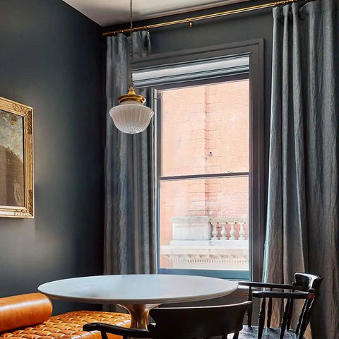 Schoolhouse Pendant Light Fixture 9 Inch Brass Gold Milk Glass Shade Adjustable Mid Century Ceiling Pendant over dining room table.