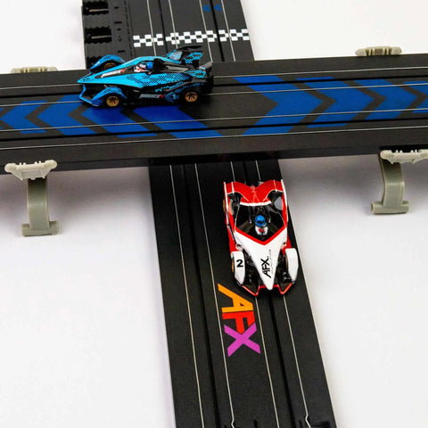 Infinity HO Slot Racing Set With Upgraded Controllers features two slot cars in action on a cross track with realistic handling.