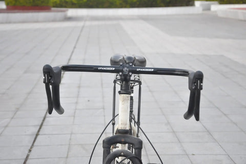 Front view of ergonomic forged aluminum drop handlebar brake levers set for road and fixie bikes with quick release cables