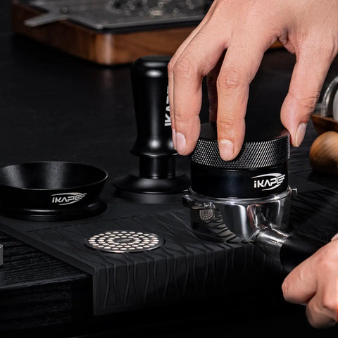 58Mm Espresso Tool Kit 6 In 1 with tamper, distributor, and mat in use, showcasing precise espresso preparation.