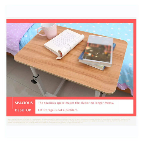 Adjustable Height Rolling Overbed Table With Easy Glide Casters For Bed Sofa Or Recliner Solid Sturdy Laptop Desk, spacious wooden surface with books and cup.