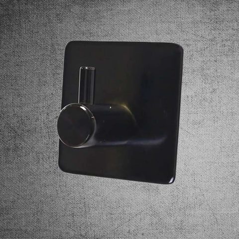 Rock Solid Black Stainless Steel Adhesive Wall Hook For Coats Towels And Umbrellas With No Hassle Peel Stick Mount Zero Drill Setup And Slick Modern Design For Bathrooms And Hallways, showcased on a textured background.
