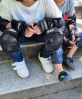 Children wearing 3 In 1 Protective Gear Set For Kids Ages 3 To 11 Knee Pads Elbow Pads And Wrist Guards For Inline Skating Black