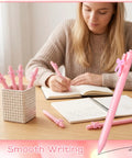Woman writing with Pink Bow Pens Set 10 Pack Aesthetic Retractable Ballpoint Pens With Cute Bow Decor, Smooth Black Ink
