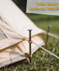 Metal Landscape Stakes Anchoring Spikes 10 Inch Long Pack Of 50 securing a tent on grass with ropes attached.