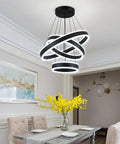 Modern Black LED Ring Chandelier With Three Adjustable Tiered Cylinders Hangs Flawlessly Over Kitchen Islands Or Bedrooms Quick Install Setup in dining area with yellow flowers.