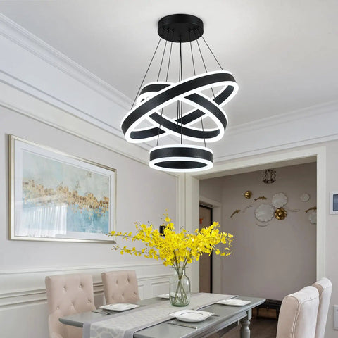 Modern Black LED Ring Chandelier With Three Adjustable Tiered Cylinders Hangs Flawlessly Over Kitchen Islands Or Bedrooms Quick Install Setup in dining area with yellow flowers.