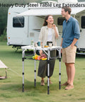Knockout Black Table Leg Extenders And Adjustable Height Risers For Folding Tables set up outdoors with fruits and drinks on a table.