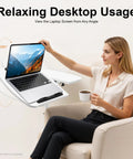 Adjustable Height Rolling Standing Desk With Locked Down Casters And Swivel Surface Lightweight Mobile Laptop Table For Home Office Over Bed No Sweat Assembly Slick White Finish, used by a woman sitting in a chair with coffee.