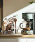 4 Pack Lazy Susan Organizer Set with clear 12 inch turntable on kitchen counter holding coffee supplies next to coffee maker.