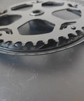 Close-up of Ride-Ready Bike Crankset with 48T 52T chainring and chain cover, showing durable steel chainring detail.