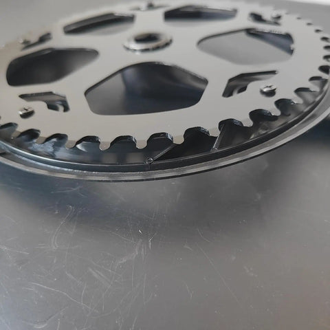 Close-up of Ride-Ready Bike Crankset with 48T 52T chainring and chain cover, showing durable steel chainring detail.