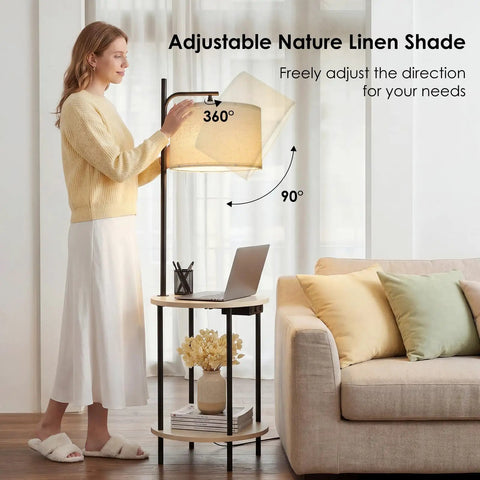 Space Saving Floor Lamp With Built In Round Table And USB Type C And USB A Charging Ports 9W LED Bulb Nightstand For Bedroom And Living Room White Ideal For Cozy Corners And Small Spaces with adjustable linen shade next to sofa.