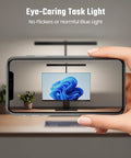Person demonstrating no flicker LED Desk Lamp For Office And Home with phone, showing glare-free light on screen.