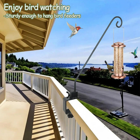 Rock Solid Heavy Duty Deck Rail Hook With 32 Inch Pole hangs bird feeders on a balcony railing, supporting 15 lbs for outdoor enjoyment.