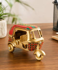 Sick Red Brass Auto Rickshaw Replica With Stone Studded Details Classic Indian Tuk Tuk Model Display Piece on wooden desk.