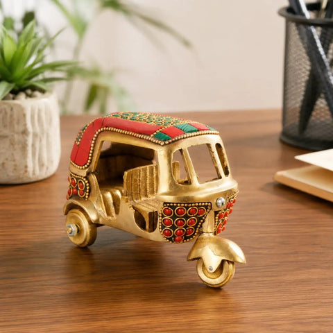 Sick Red Brass Auto Rickshaw Replica With Stone Studded Details Classic Indian Tuk Tuk Model Display Piece on wooden desk.