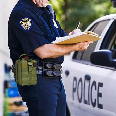 Emergency First Aid Kit IFAK With MOLLE Admin Pouch attached to police officer's belt beside patrol car