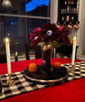Battery Operated Flameless Taper Candles With Remote And Timer on table with checkered runner and Halloween decor