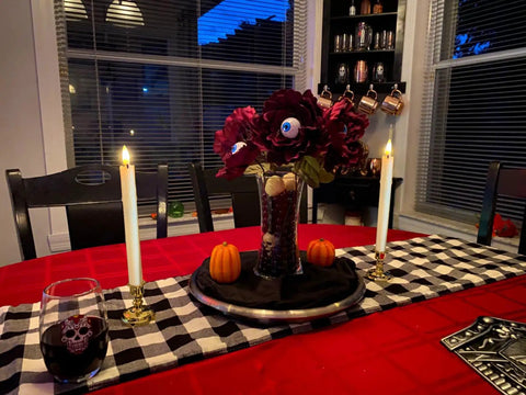Battery Operated Flameless Taper Candles With Remote And Timer on table with checkered runner and Halloween decor