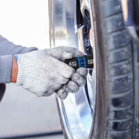 Person using Half Inch Drive Lug Nut Impact Socket Set 5 Piece Thin Wall Flip Sockets with 3 Inch Extension Bar on car tire