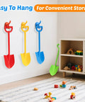 Four colorful 15-inch plastic shovels hanging for storage; 4 Piece 15 Inch Beach Sand Shovel Set for Kids, Colorful Outdoor Digging Toys.