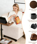 Slim C Shaped End Table With Adjustable Height And 360 Degree Swivel Mobile Laptop Desk On Wheels next to sofa with snacks