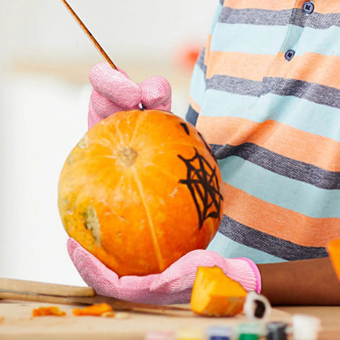 Child carving pumpkin wearing Kids Cut Resistant Gloves Level 5 Protection For Cooking Wood Carving Whittling Gardening And DIY Projects Food Grade Safe Small Size For Ages 4-6 Years Pink Green Or Gray