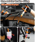 Hydraulic Bike Brake Bleed Kit For Shimano, SRAM, Tektro, And Magura using dual syringes in a workshop setting.