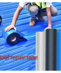 Person applying blue waterproof heat insulation tape for roof repair self adhesive leakproof crack sealing tape, shown in close-up.