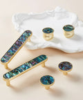 Pearl Shell Cabinet Knobs With Abalone Inlay, Slick Brushed Gold Zinc Alloy Drawer Pulls displayed on decorative plate