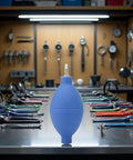 Blue Rubber Soft Cleaning Tool For Wristwatch Parts On The Go, Dust Air Blower Pump on a workbench, pocket size