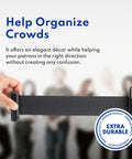 Hand extending black belt from 36-Inch Stanchions Set Of 2, 6.5-Foot Retractable Belt, Boss-Grade Heavy-Duty Steel, for event crowd control