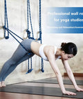 Wall Mounted Yoga Rope Kit For Deep Stretching And Spinal Mobility Posture Support Back Shoulder Hip Tension Relief Home Or Studio Practice Easy Setup Pro Grade Durable Anchor System, woman using blue wall ropes in yoga studio