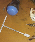High Carbon Steel T Handle Socket Wrench With Hex Grip on a workbench, showcasing durability and multipurpose use for mechanics.